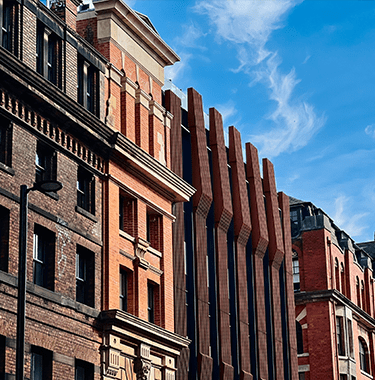 A wide shot of tall brick city centre buildings.