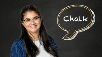 A woman with long brown hair smiling against a chalkboard that says chalk.