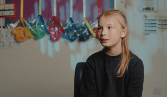 Shot of a young girl sitting to the right